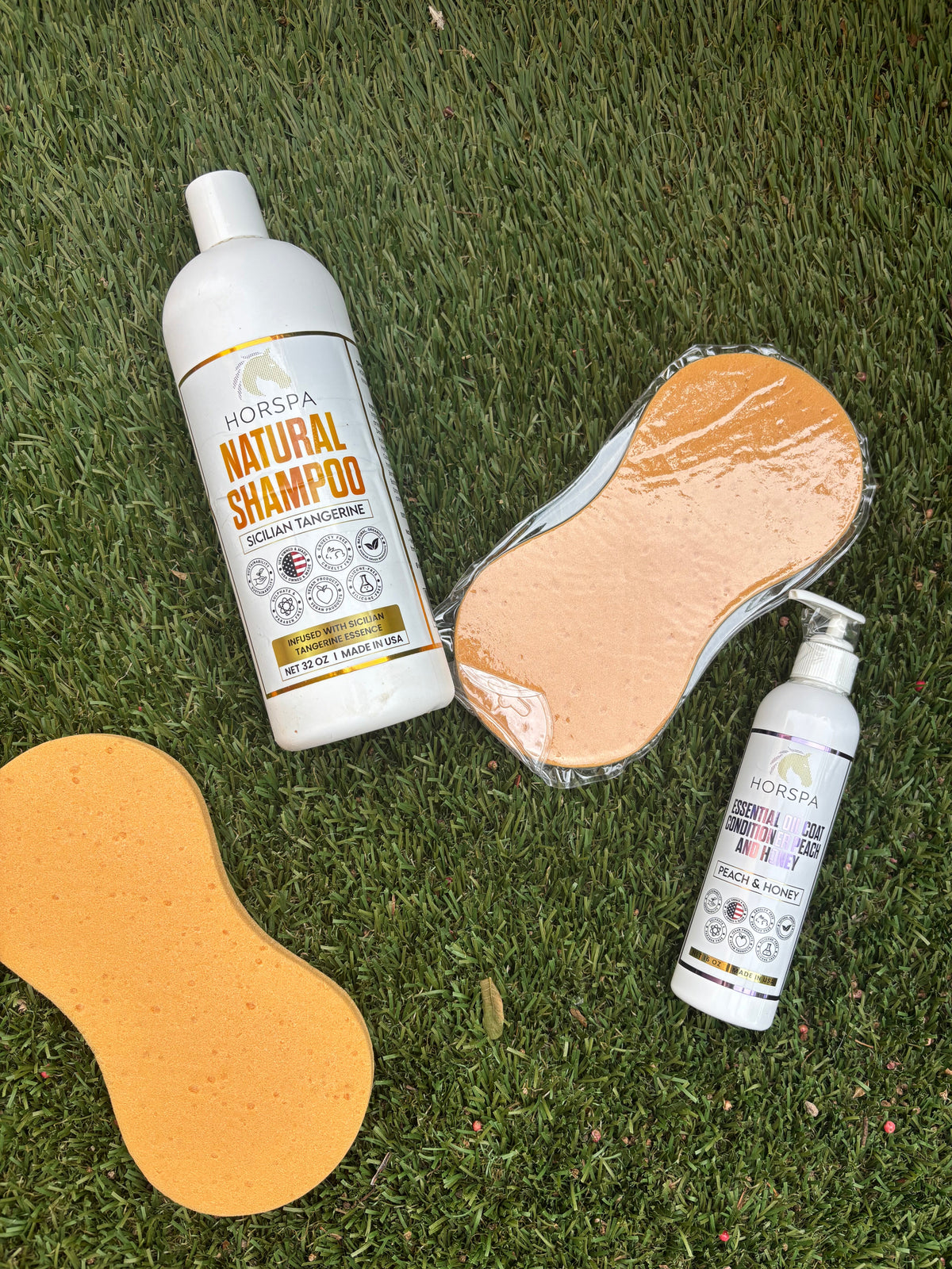 Horspa Natural Shampoo bottle with orange sponges and small Essential Oil & Conditioner spray