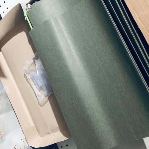Stack of dark green legal hanging file folders partially visible in open box