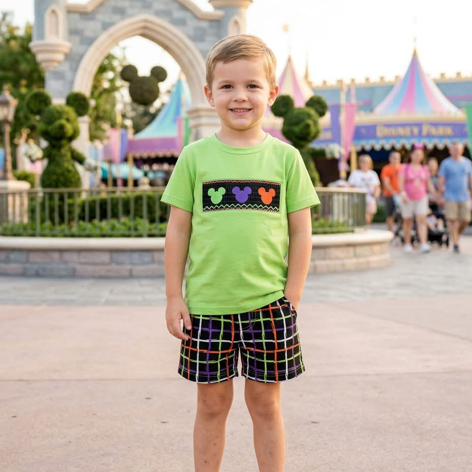 Kids green T-shirt with mouse graphic and plaid smocked shorts on model