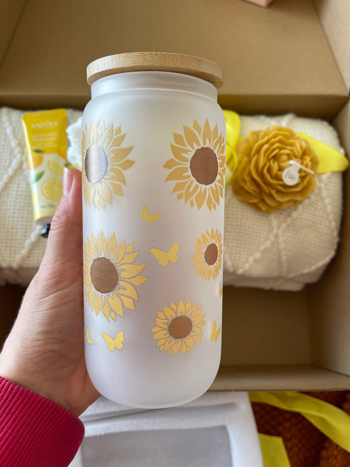 White candle jar with sunflower pattern in yellow gift care package