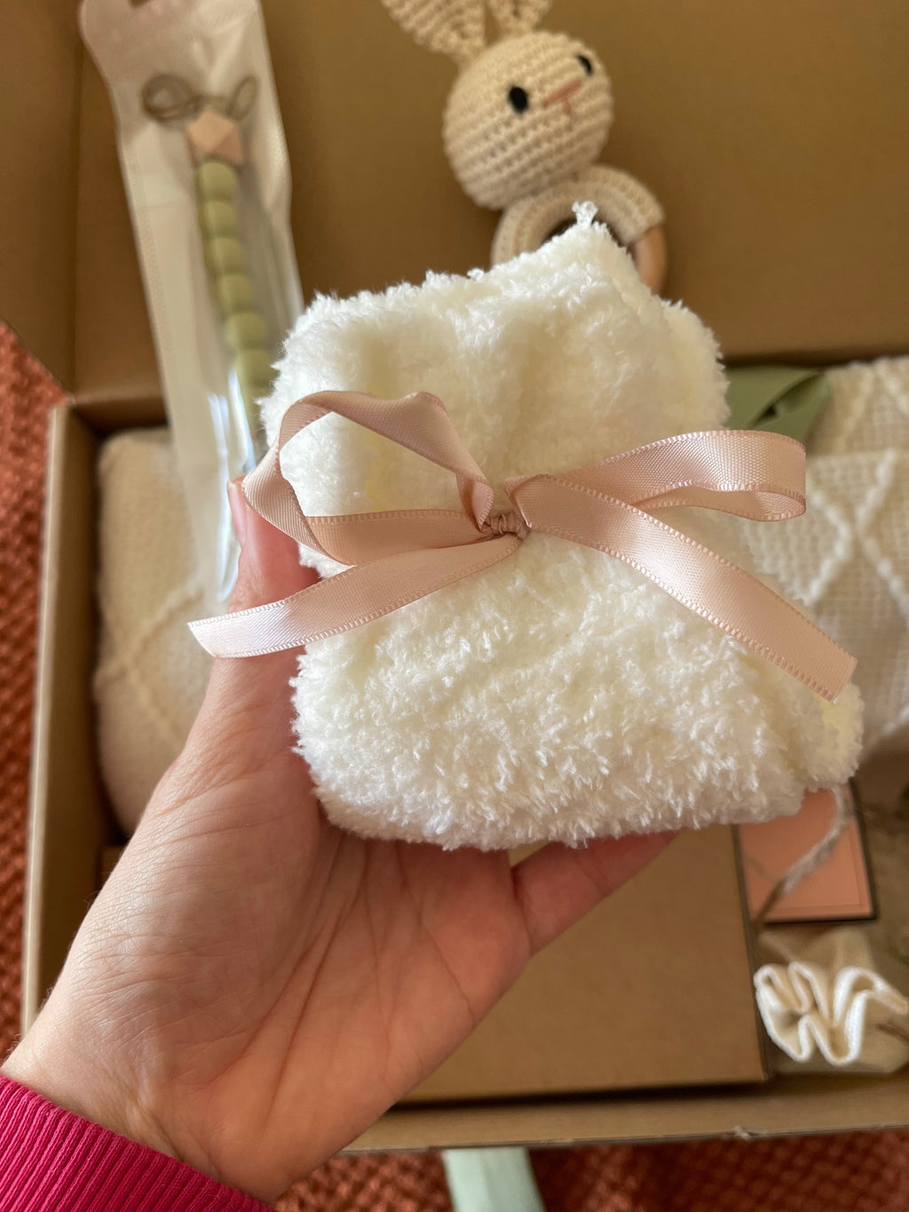 White plush bunny gift pouch tied with pink satin ribbon
