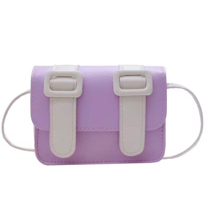 Mini color pop satchel bag, lavender purple with white buckle straps and adjustable crossbody cord.