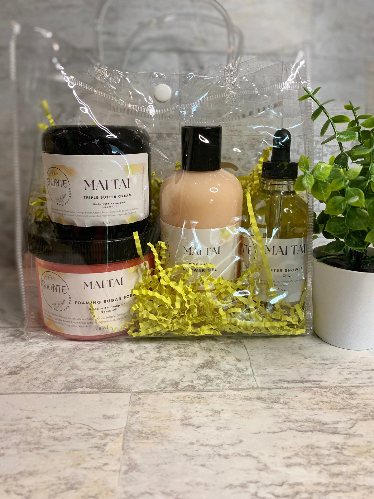 Mai Tai bath set bundle in clear bag: black jars, cream bottle, and oil vial.