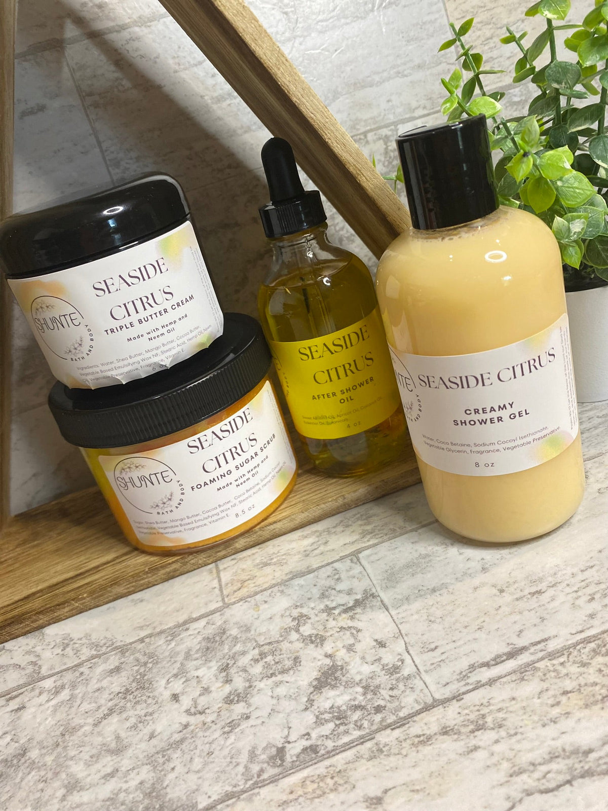 Seaside Citrus bath set bundle with cream jar, amber oil, and yellow shower gel bottle.