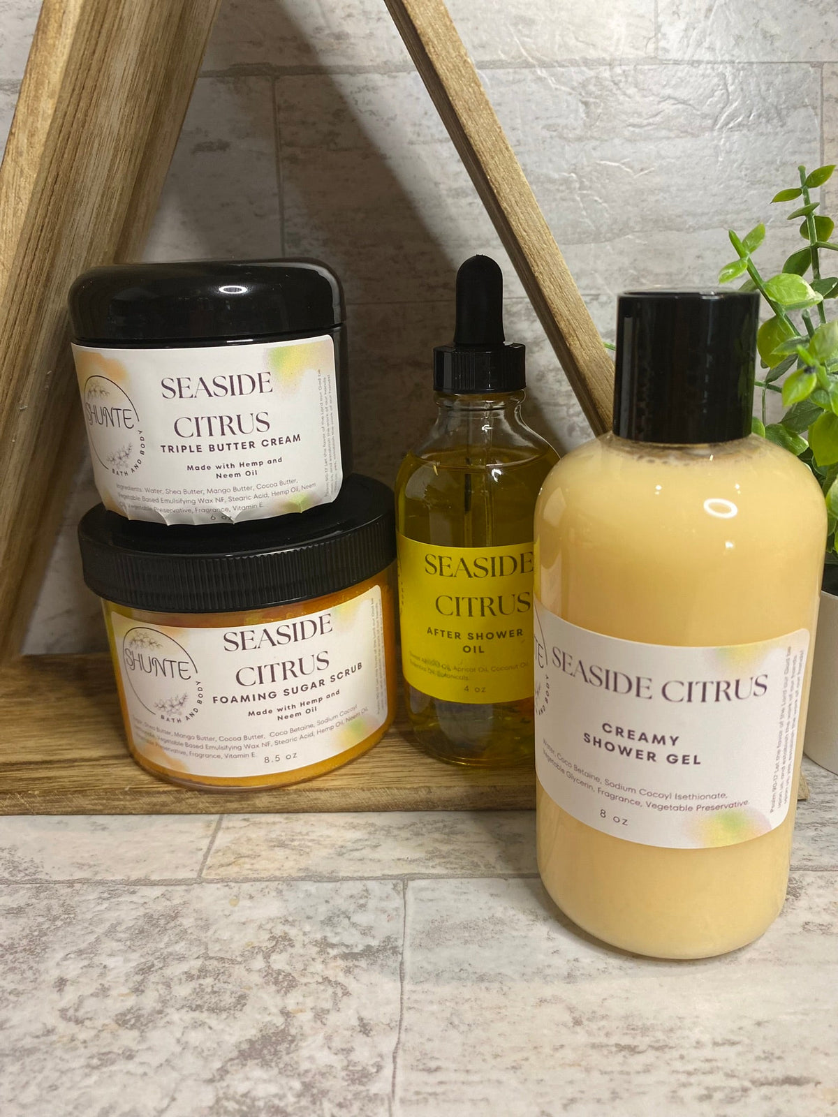 Seaside Citrus bath set bundle: cream jar, amber oil dropper, and yellow shower gel bottle.
