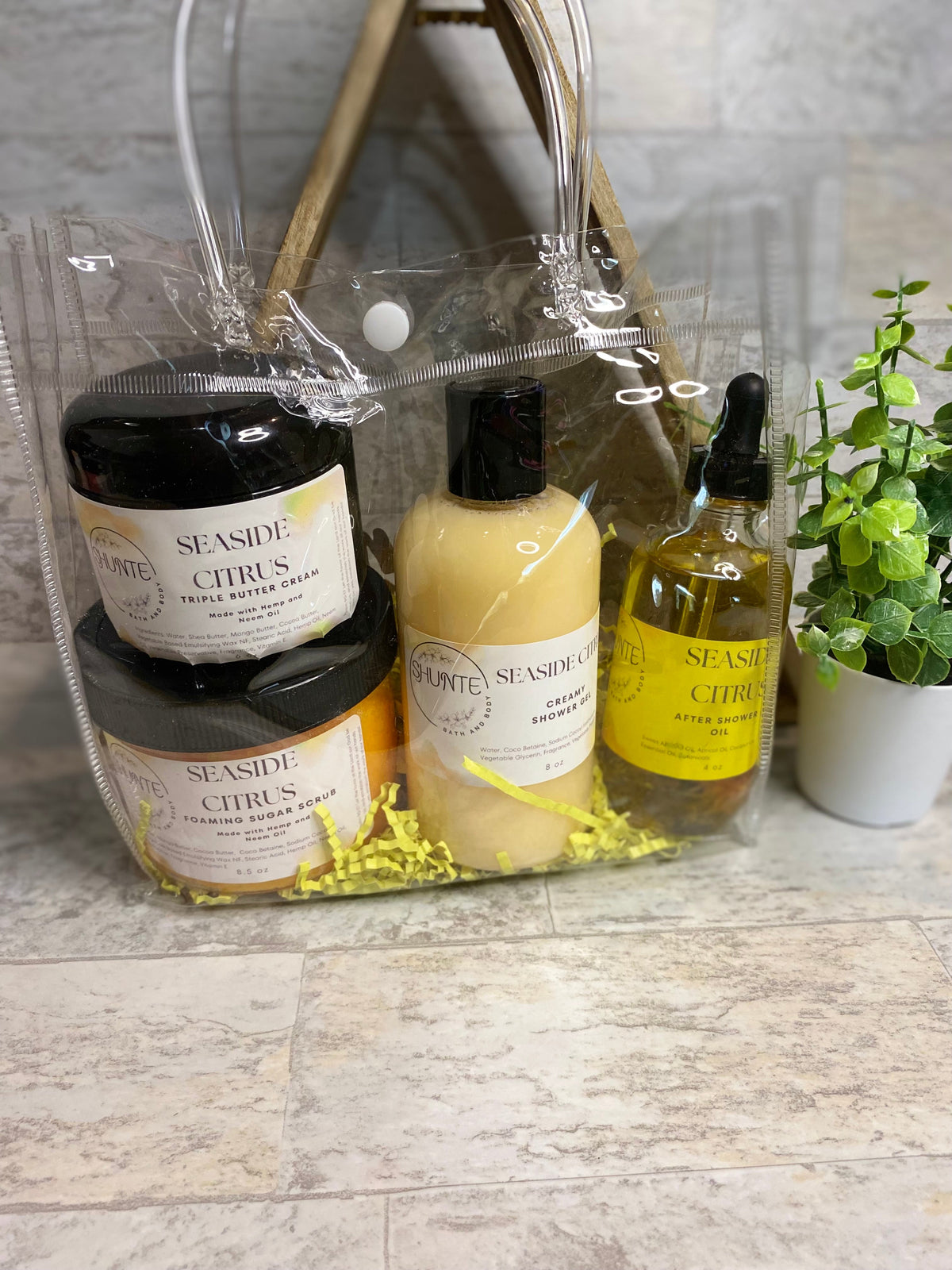 Seaside Citrus bath set bundle: clear bag with black jar, cream jar, and yellow shower bottle.