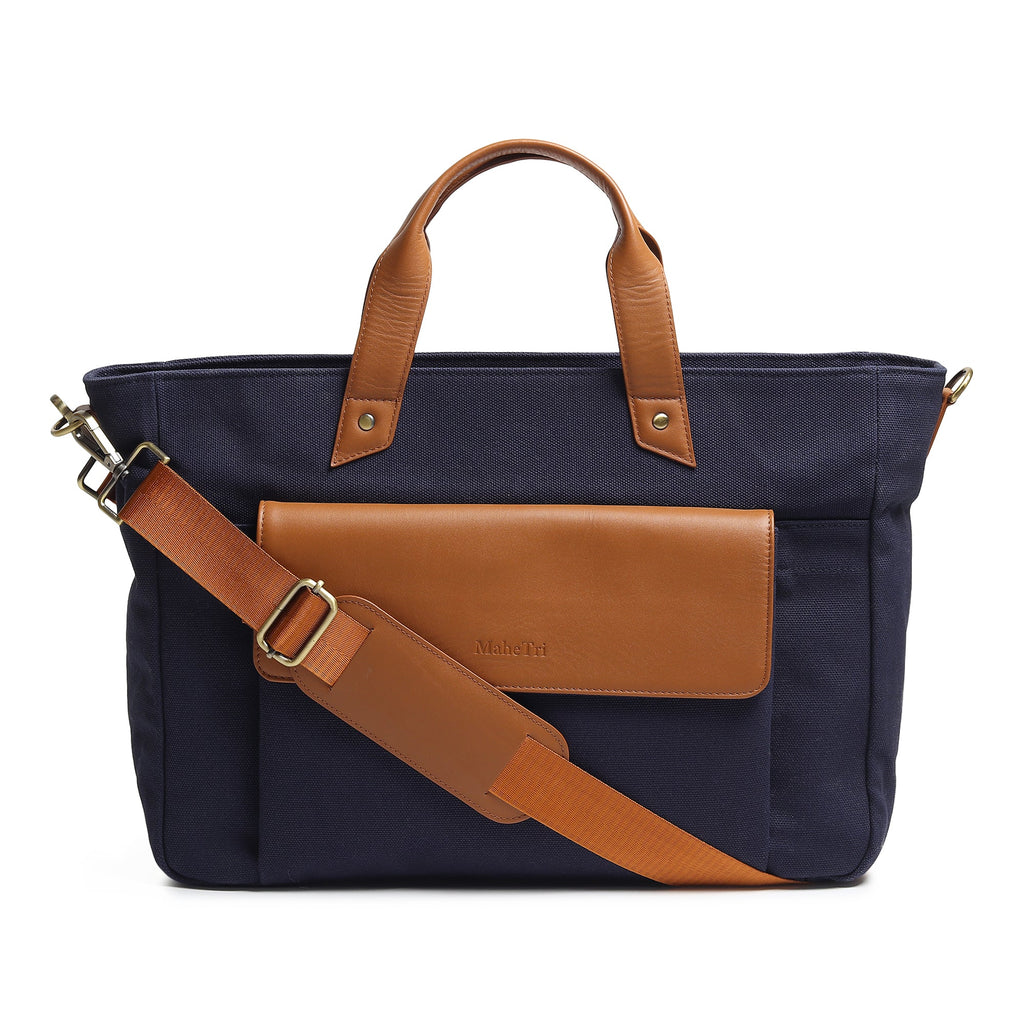 Dark blue canvas briefcase with tan leather handles and crossbody strap