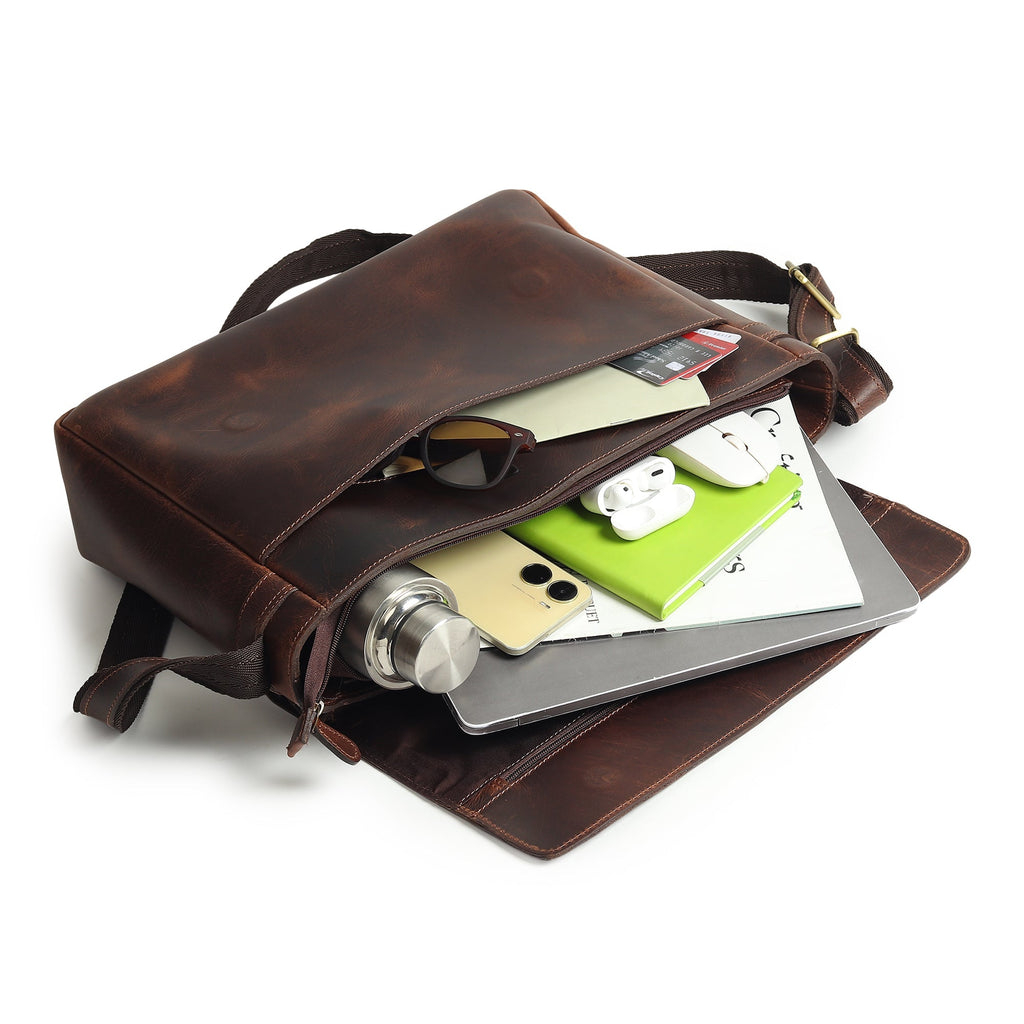 Genuine Sitka leather laptop bag open with electronics and documents inside, dark brown.