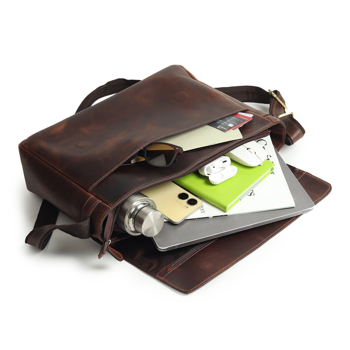 Genuine Sitka leather laptop bag open with electronics and documents inside, dark brown.