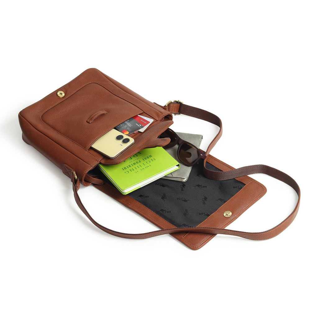 Brown leather crossbody bag interior holding cards and small items