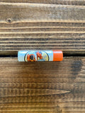 Chap-stick lip balm stick with orange cap and cartoon label