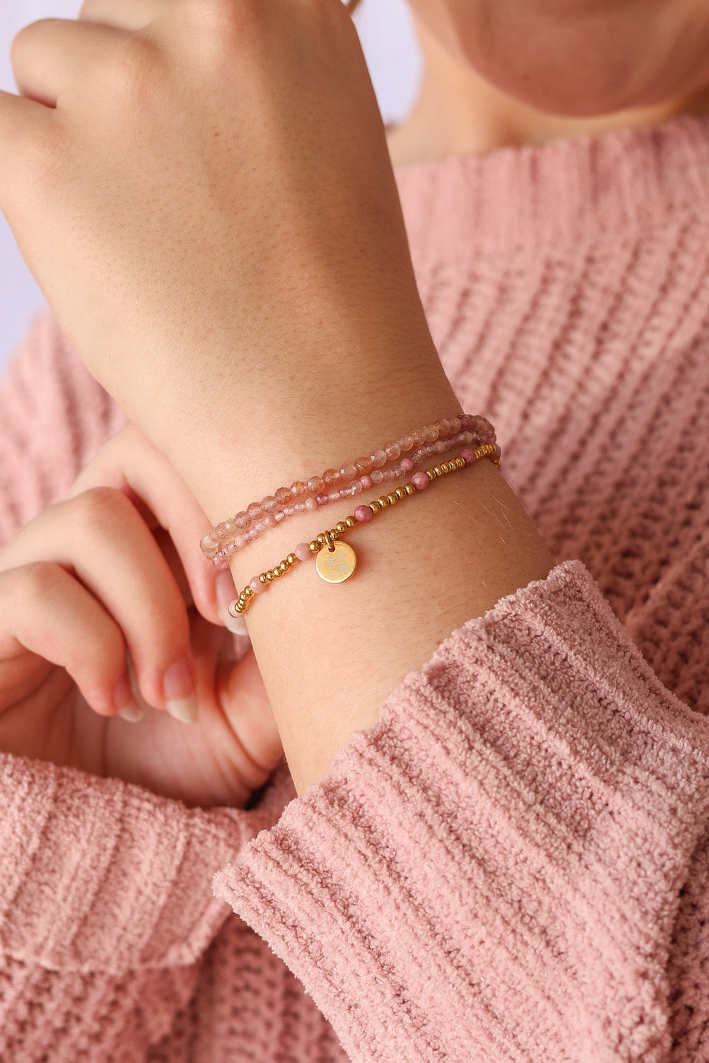 Bead stretch bracelet set with gold-tone charm and pink-and-gold bead strands