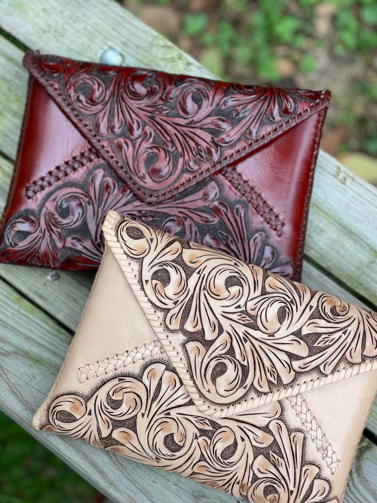 Hand-tooled leather crossbody & clutch bag pair: red and tan, floral embossed with stitched border
