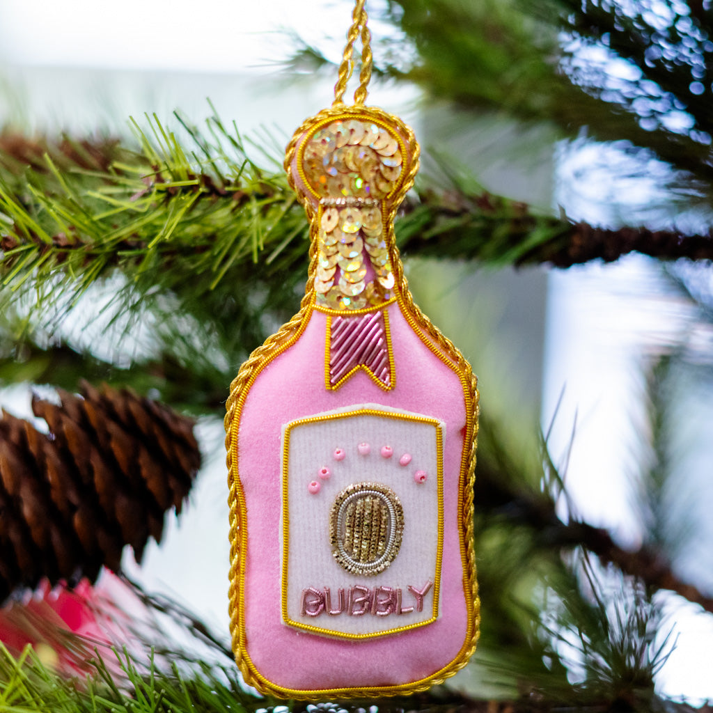 Pink velvet champagne bottle ornament with gold glitter neck and 'CUBBY' label