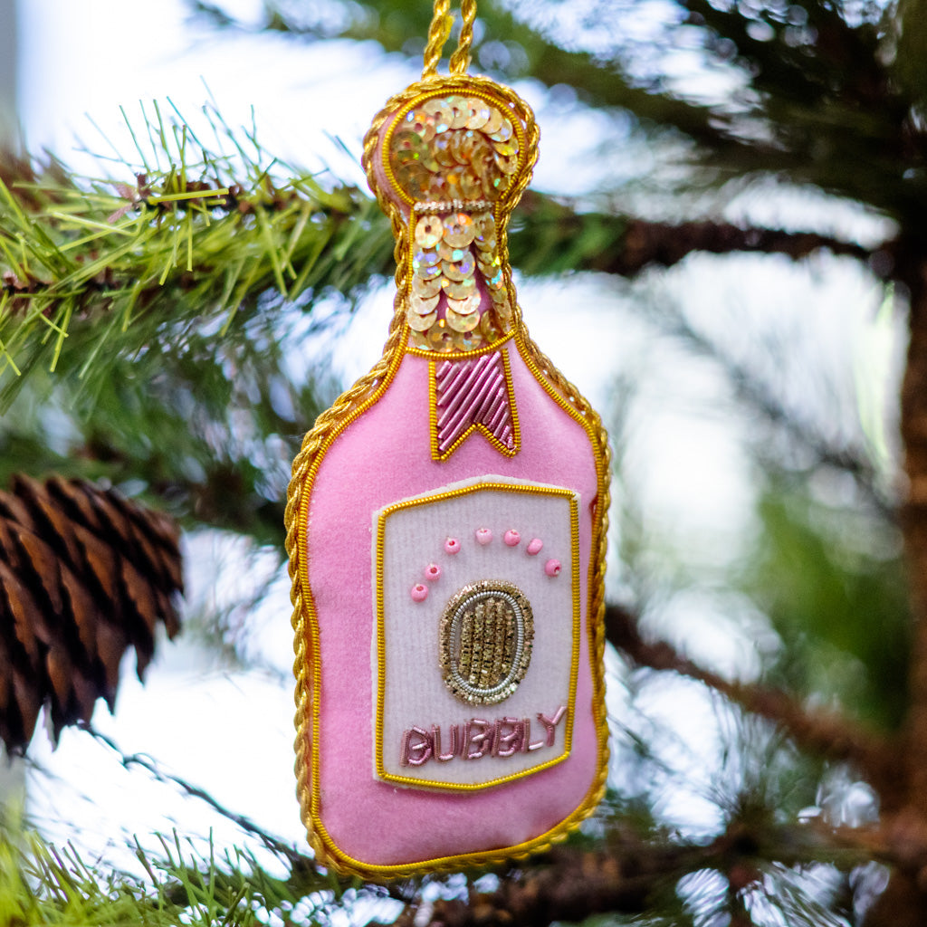 Pink velvet bottle ornament with gold trim and oval 'CUBBY' badge, hanging on loop