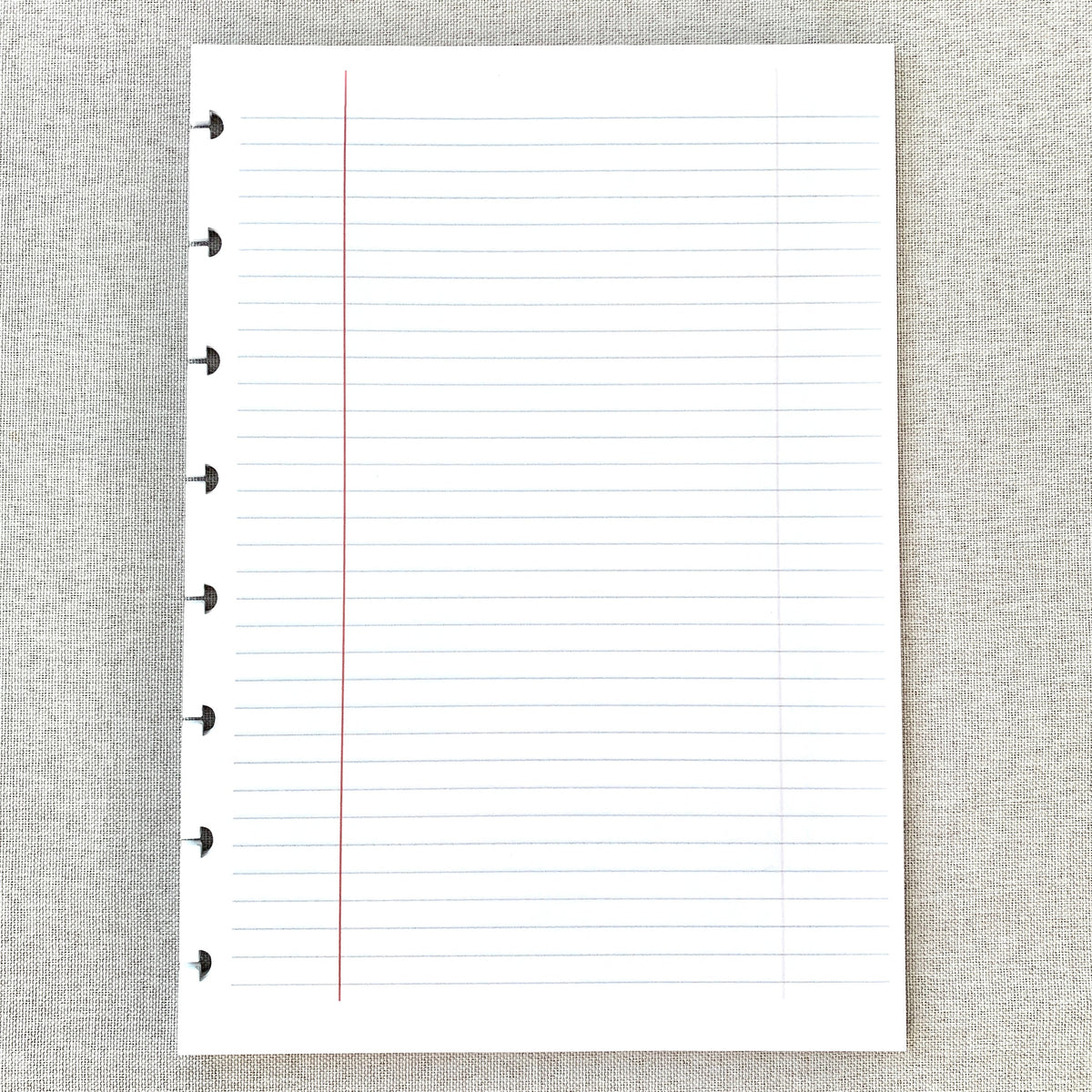 A5 lined discbound paper insert with red margin line and punched ring holes