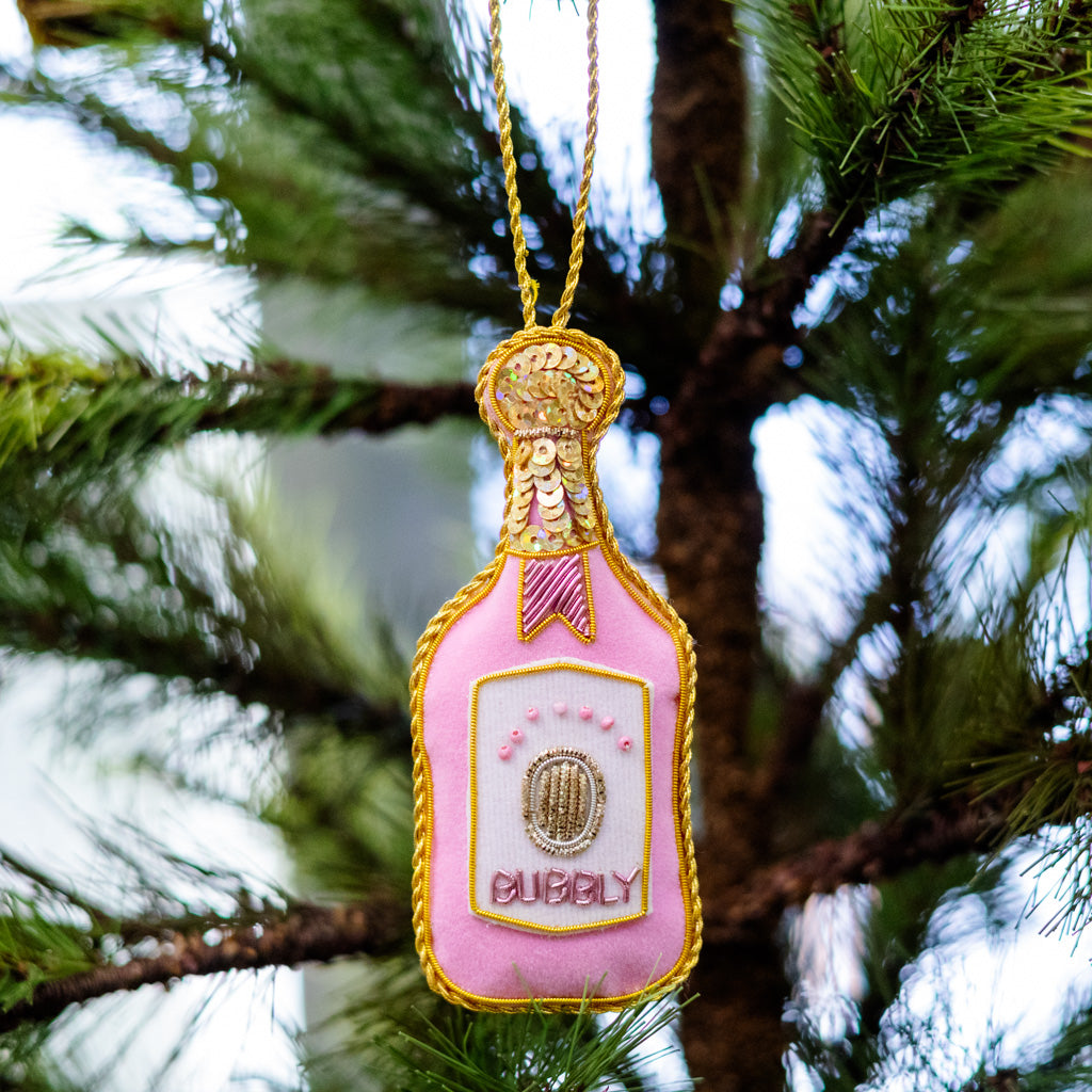 Pink velvet champagne bottle ornament with gold glitter trim and hanging loop