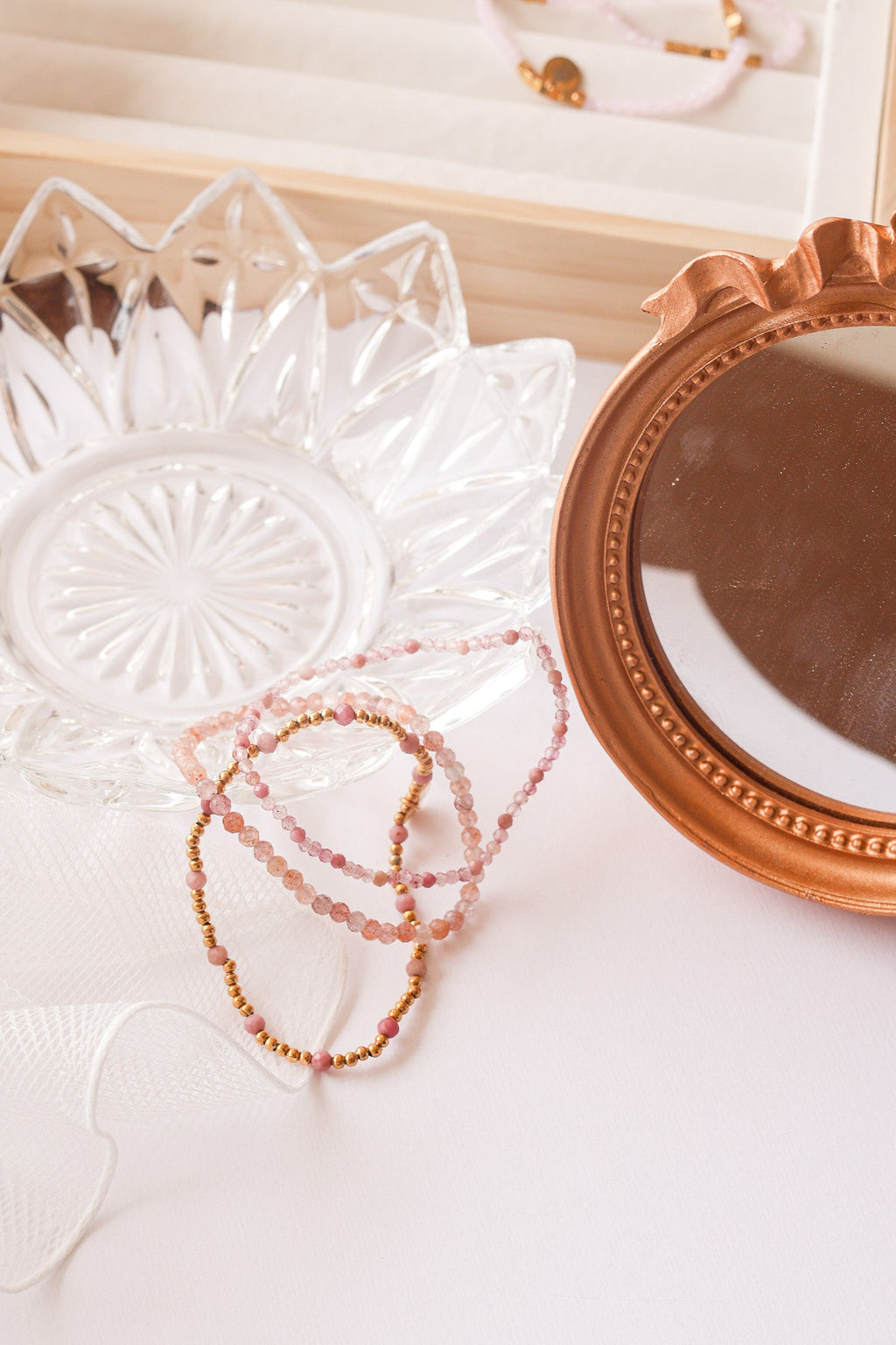 Bead stretch bracelet set with pink beads and gold-tone charms in layered strands