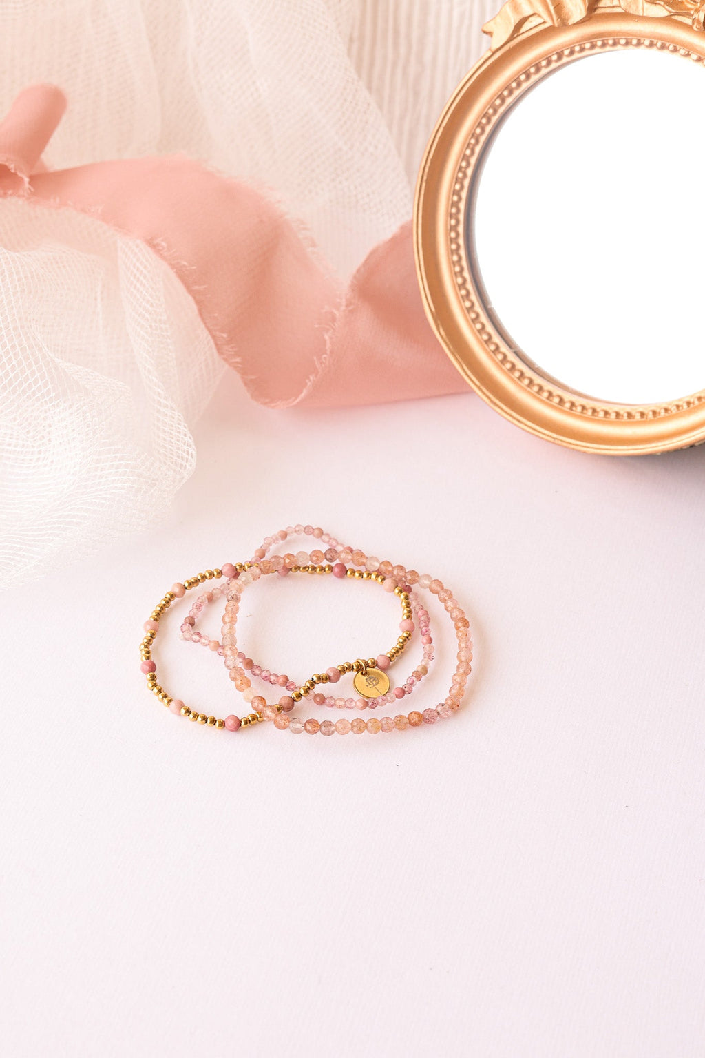 Three-piece bead stretch bracelet set with round pink beads and gold-tone charms
