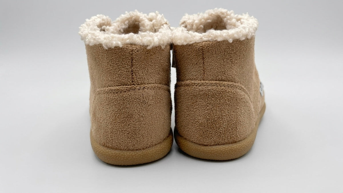 Tan toddler barefoot winter boots from the back, plush shearling cuffs