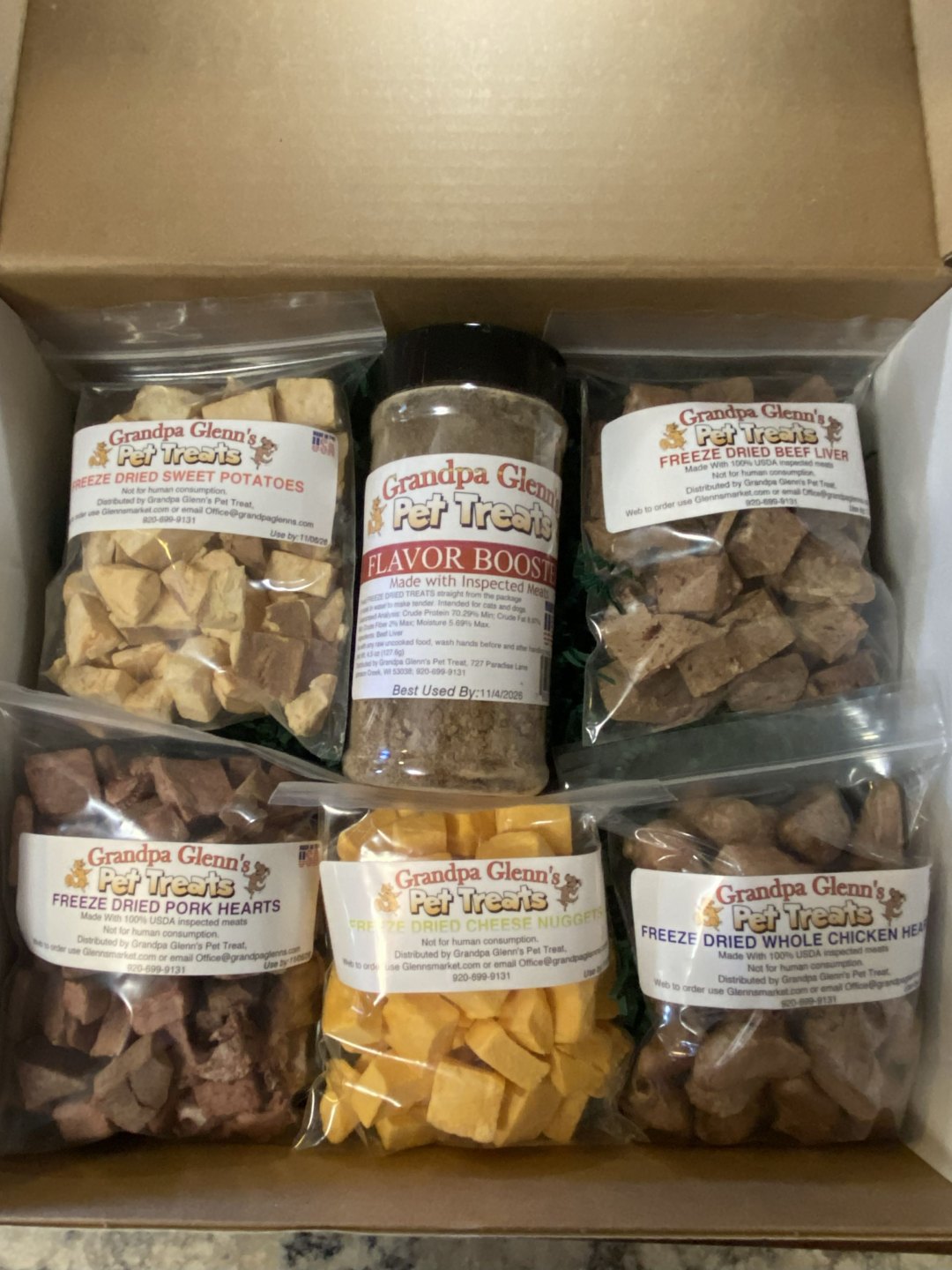 Pet treat gift box with mixed freeze-dried dog treats and a flavor boost jar