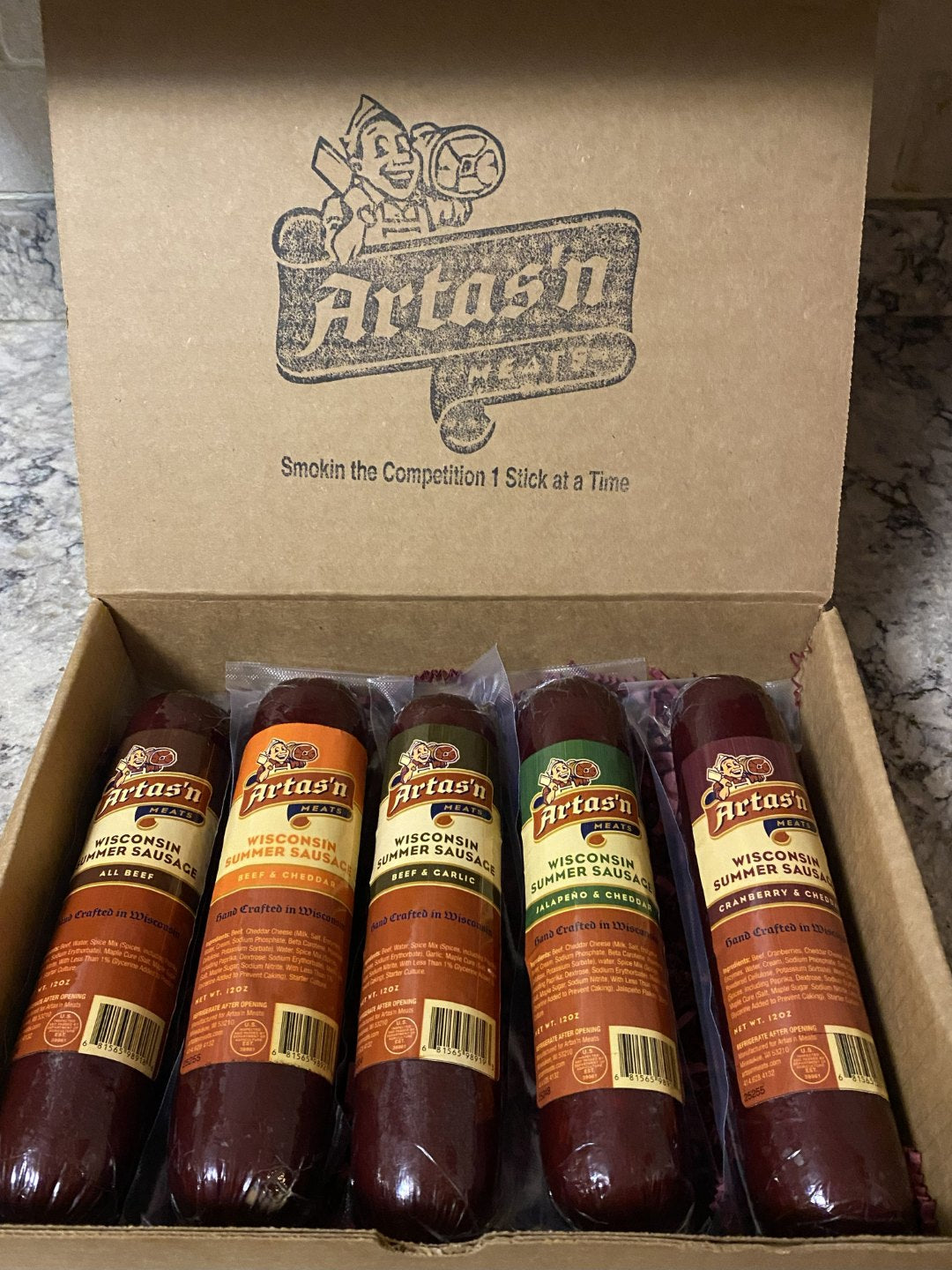 Smoked sausage gift box with five vacuum-sealed sausages in clear casings