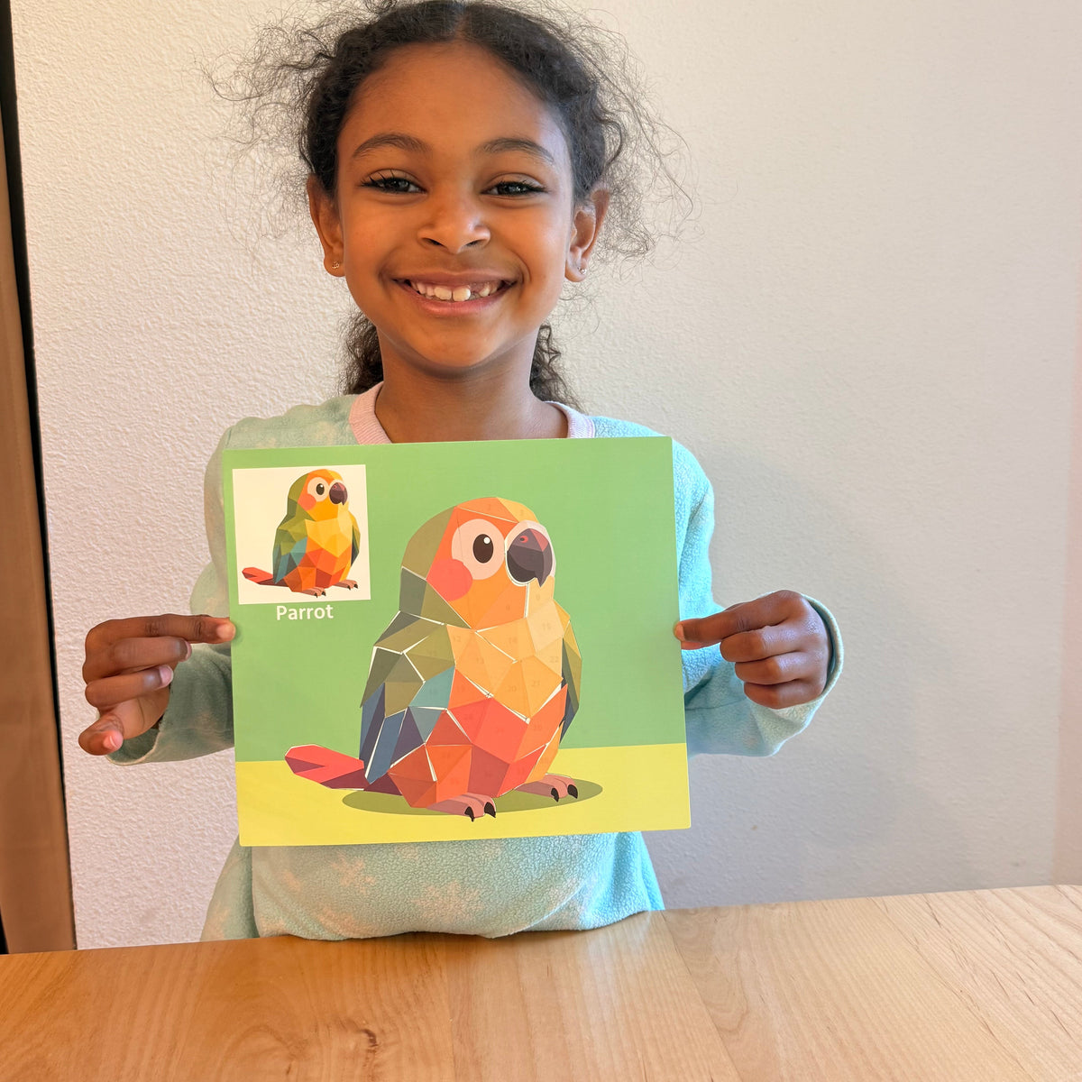 Kids sticker puzzle painting sheet with colorful parrot and toucan designs, held by child