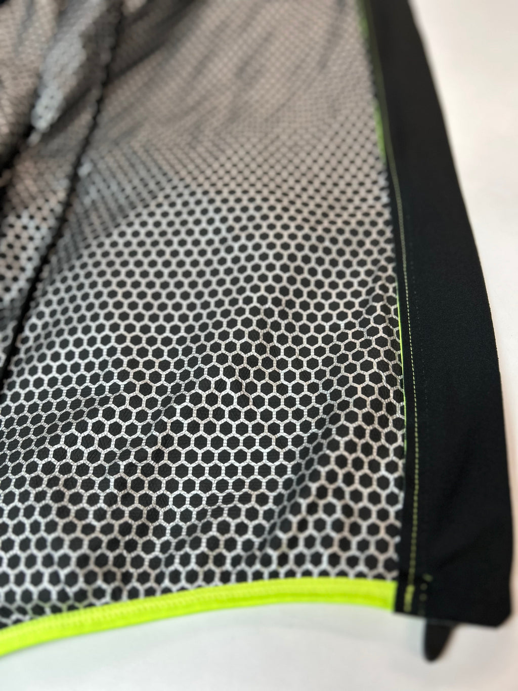Close-up of jacket mesh lining with neon lime edge trim