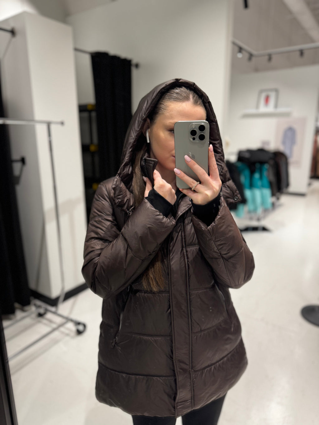 Chocolate hooded puffer jacket on model, full zipper and drawstring hood