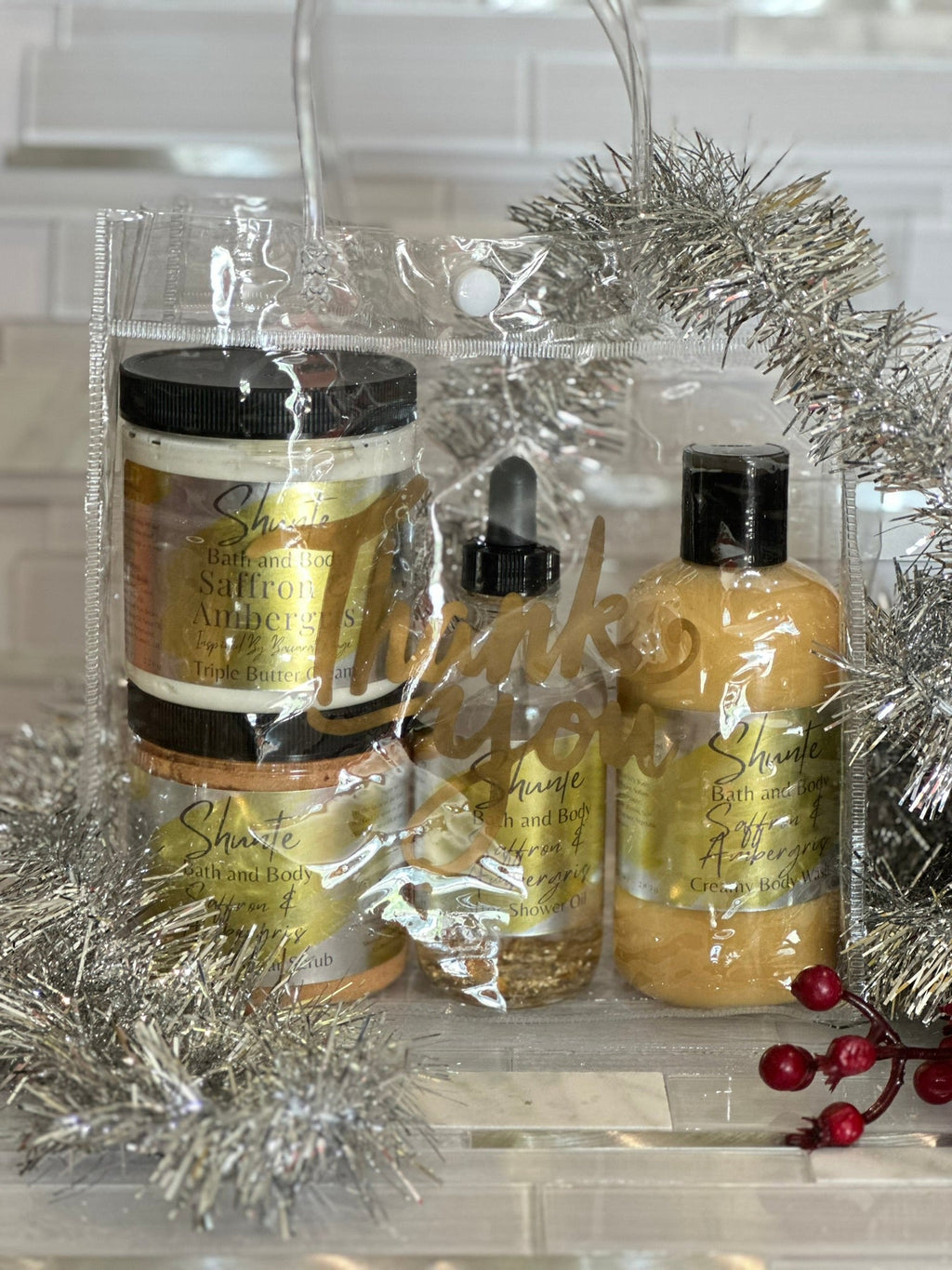 Bath and body gift set (4 items): gold jars, dropper oil, amber pump bottle, in clear bag