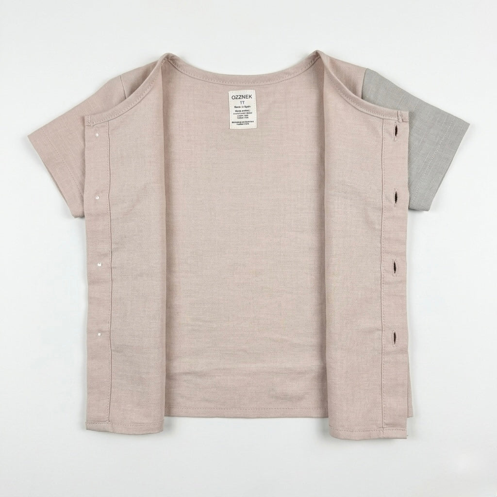 Toddler button-up shirt, back view in light oatmeal pink, short sleeves and side buttons