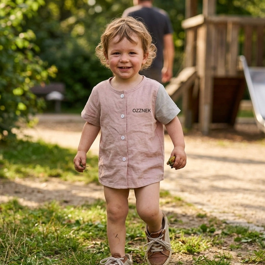 Toddler button-up shirt in light oatmeal pink, front buttons, short sleeves on child