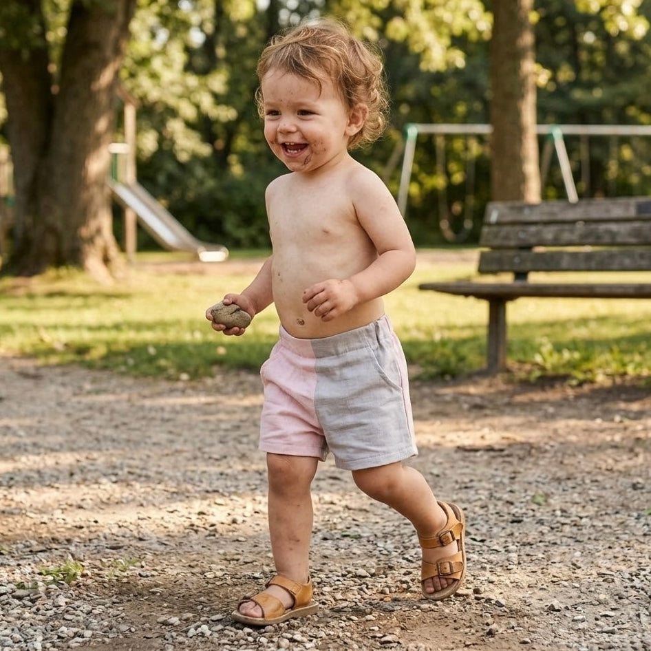 Toddler shorts in pink and light gray panel colors, worn outdoors