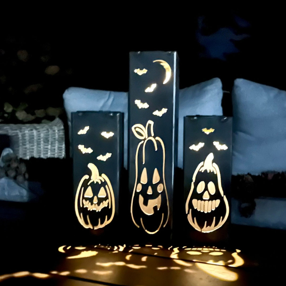 Solar steel tube lights with glowing jack-o-lantern and bat cutouts