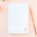 White sketch memo notepad with blue line icons, clouds, and mountain doodles on cover