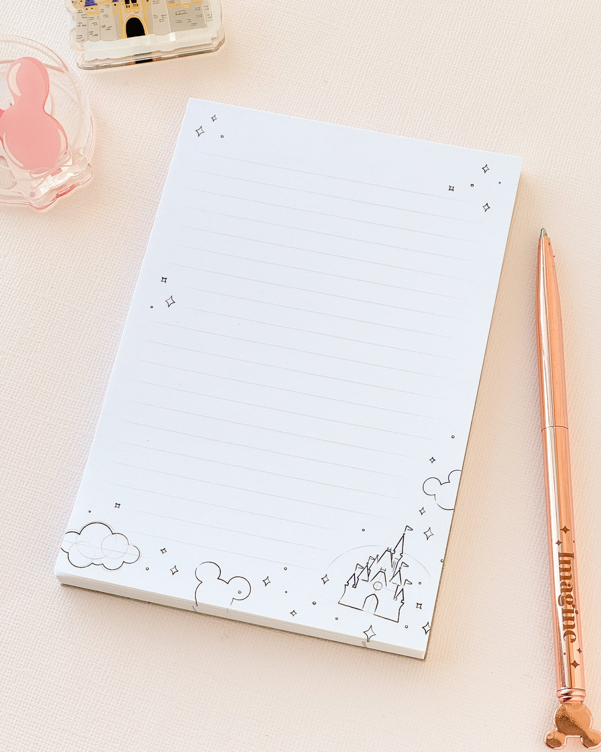 Sketch memo notepad with lined pages and blue cloud and mountain border doodles