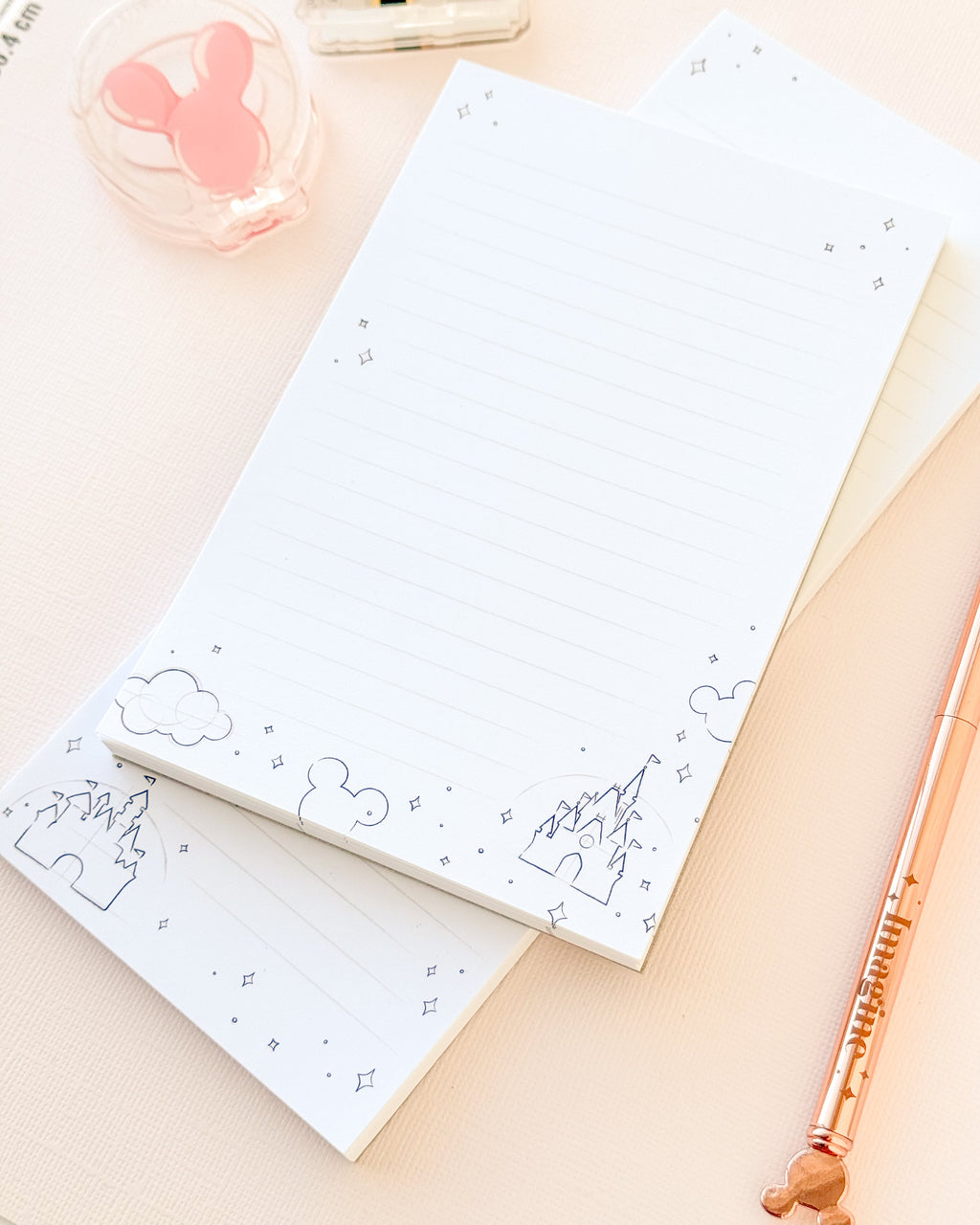 Two-sheet sketch memo notepad with lined paper and blue clouds and mountain illustrations