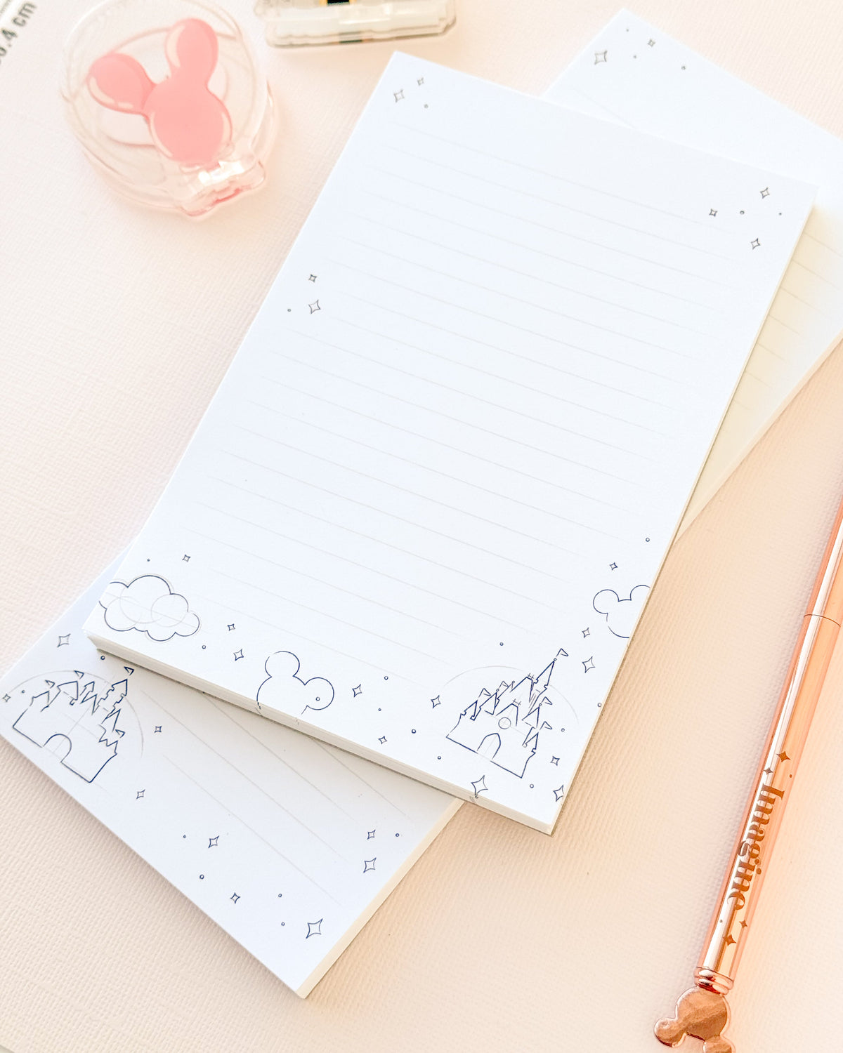Two-sheet sketch memo notepad with lined paper and blue clouds and mountain illustrations