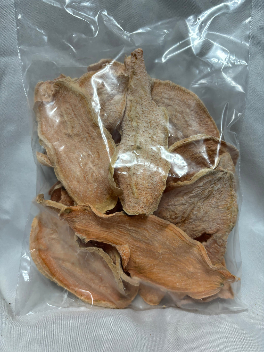 Clear bag of dehydrated sweet potato slices for dogs.