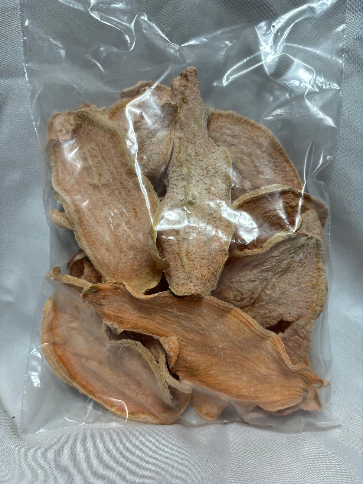 Clear bag of dehydrated sweet potato slices for dogs.