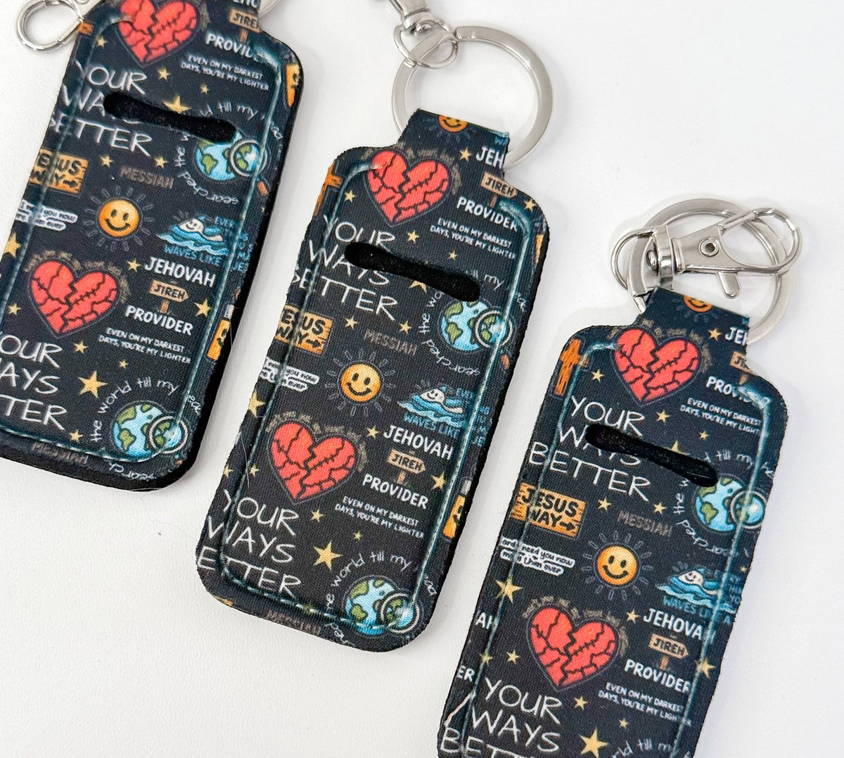 Dark patterned chapstick holder pouch with keyring, hearts, smiley, and slogan print