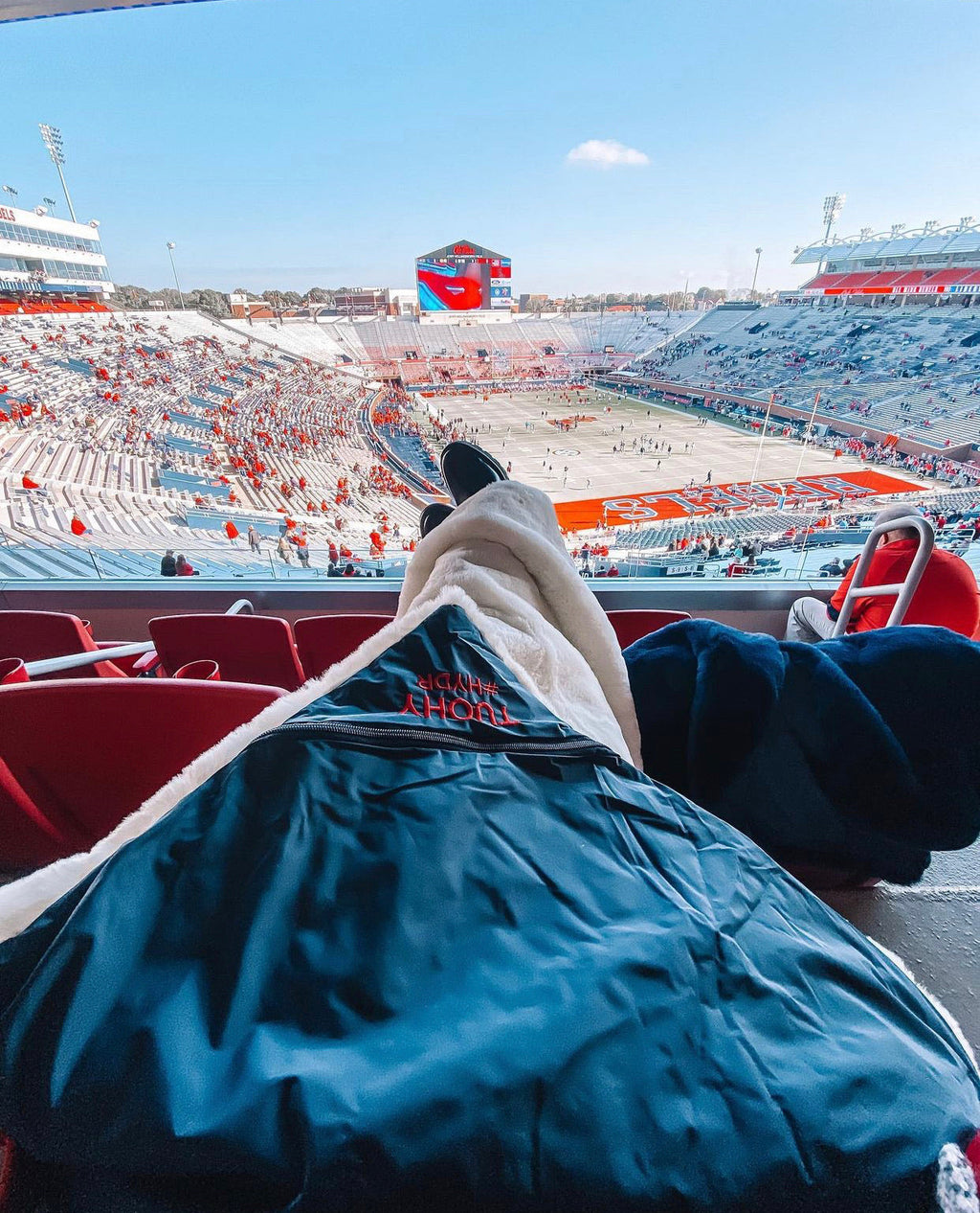 Large outdoor blanket, navy blue with soft plush lining on stadium seat