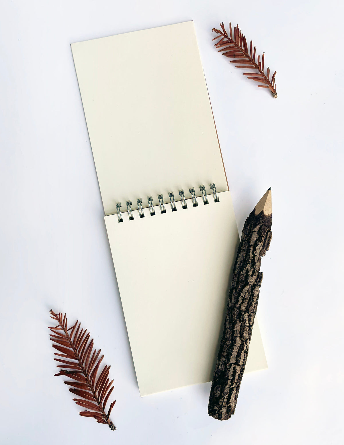 White spiral notebook with metal coil binding and blank cover