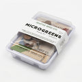 Microgreens seed-starting kit with clear plastic seed tray and labeled seed packets