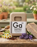 Gardener's hand soap bar beside soap container with floral label