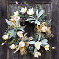Sage wreath with white blossoms, eucalyptus leaves, blue thistle accents, and seeded stems