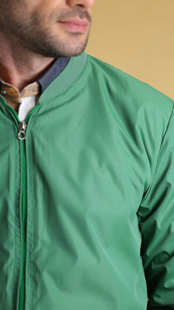 Green zip-front jacket close-up with stand collar and zipper