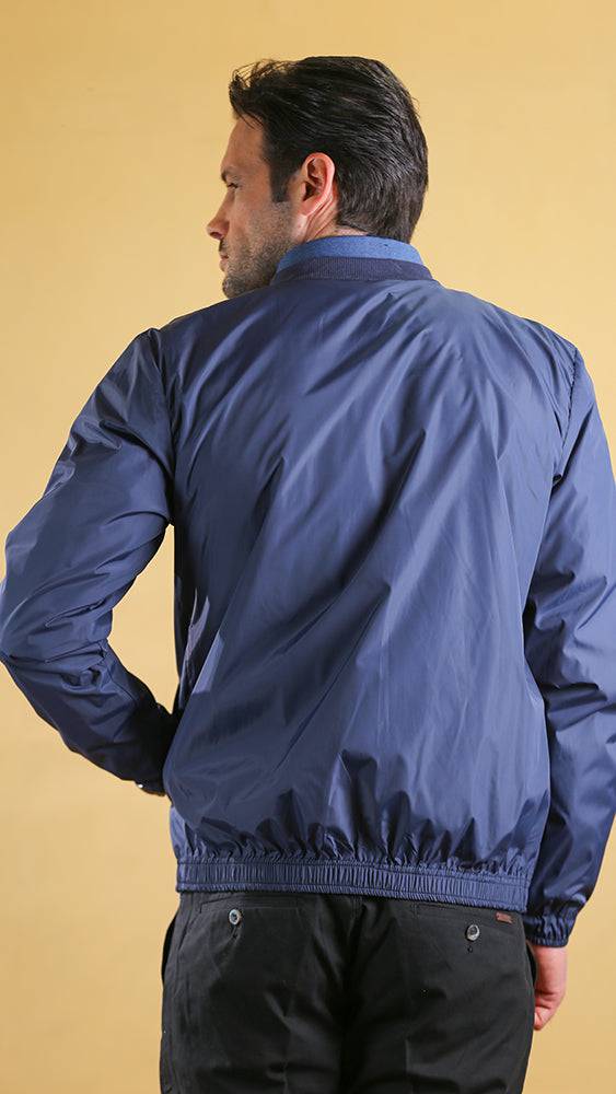 Dark blue lightweight spring jacket shown from back with ribbed hem and cuffs