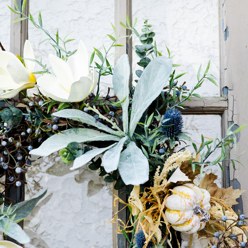 Sage wreath corner view with white blooms, eucalyptus leaves, blue thistle, and berry sprigs