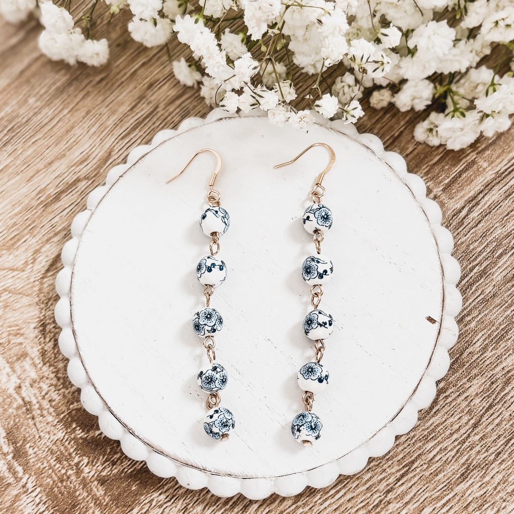 Blue and white porcelain drop earrings with stacked round beads on gold-tone hooks